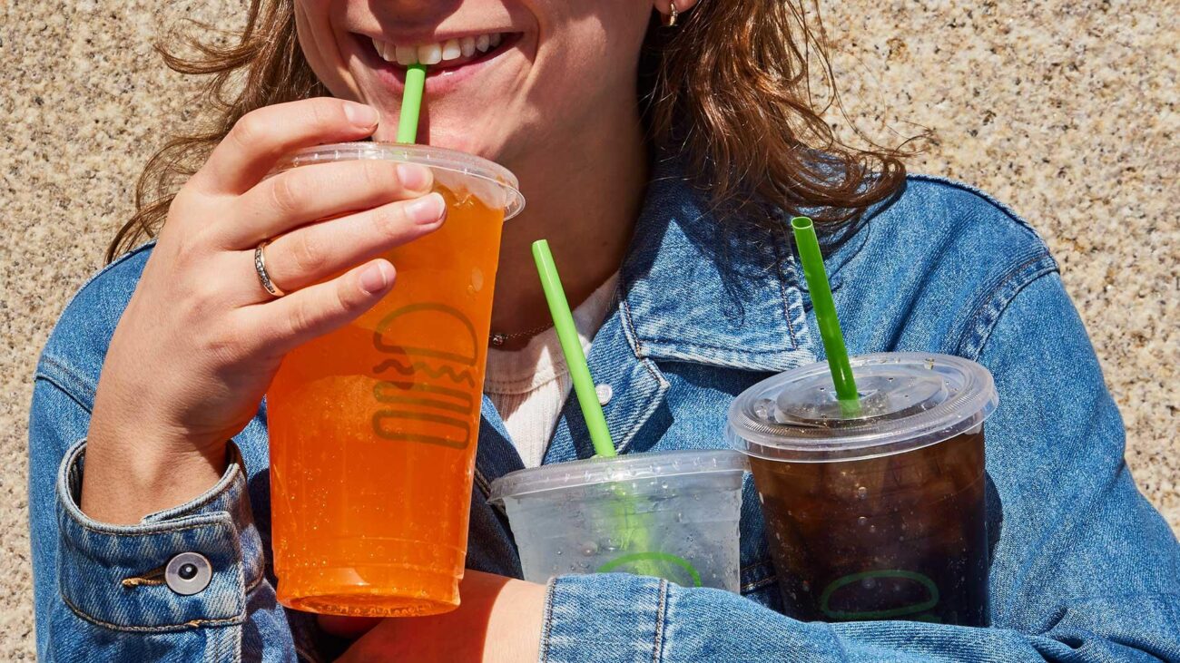 woman drinking soda pop from shake shack orange fanta