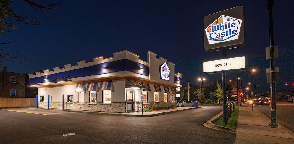 white castle at night with an empty parking lot and lit up