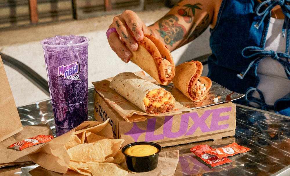 taco bell cheesey streetchalupas meal hand holding taco